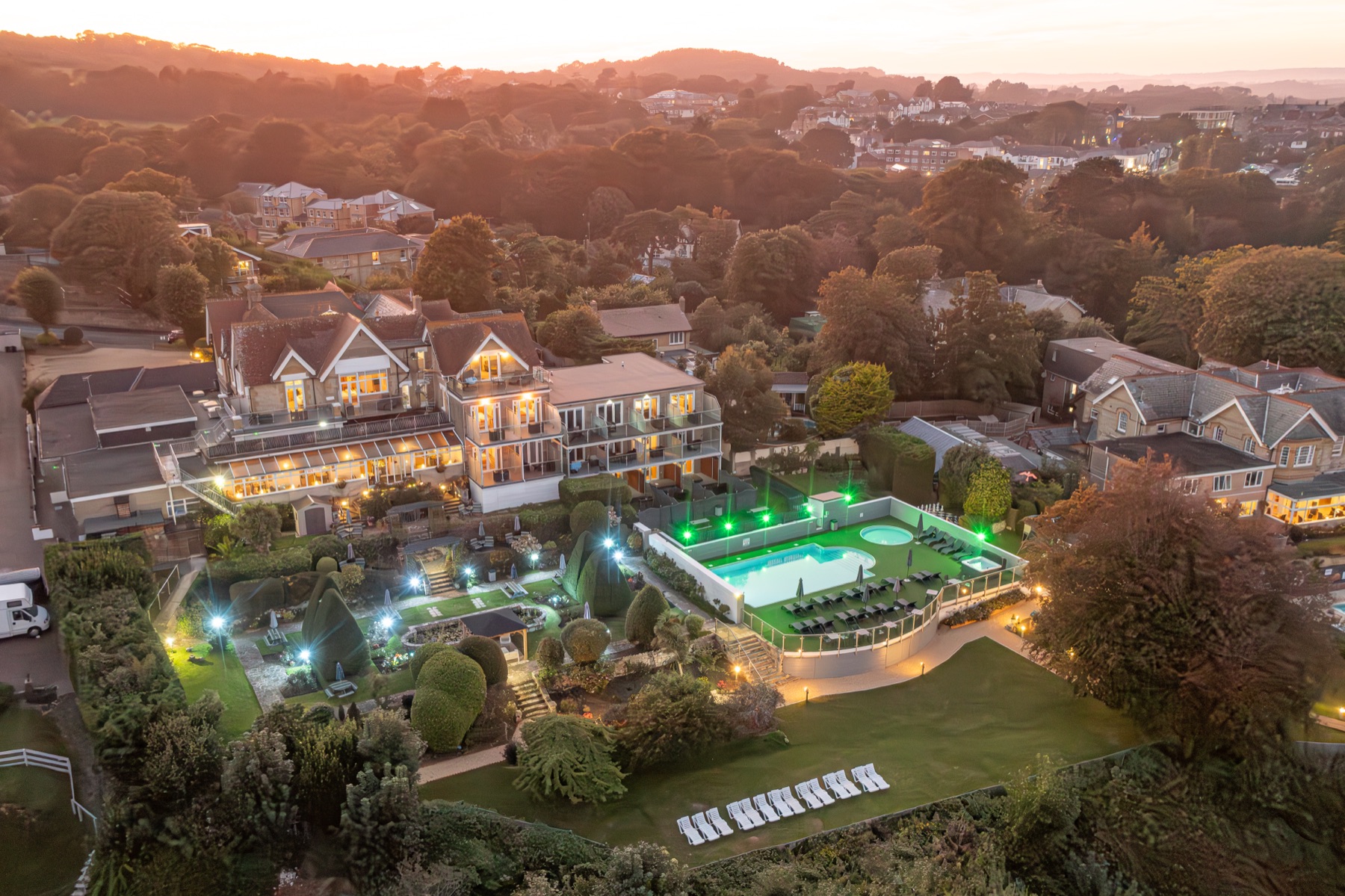 Luccombe Hall lit up at dusk, from the air